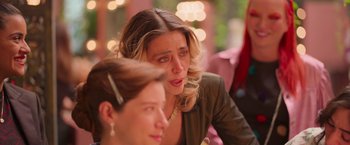 Movie still from “Making It Up” (2023), directed by Guillermo Calderón – Two women are sitting at a table and one of the women is crying; Close Up shot, Over the shoulder angle