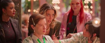 Movie still from “Making It Up” (2023), directed by Guillermo Calderón – A woman is looking at another woman in a green dress; Close Up shot, Over the shoulder angle