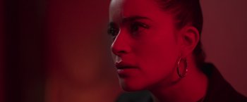 Movie still from “Making It Up” (2023), directed by Guillermo Calderón – A woman's face in red light; Extreme Close Up shot, Over the shoulder angle