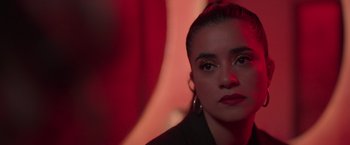 Movie still from “Making It Up” (2023), directed by Guillermo Calderón – A person wearing a black jacket; Close Up shot, Over the shoulder angle