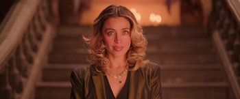 Movie still from “Making It Up” (2023), directed by Guillermo Calderón – A beautiful woman with blonde curly hair wearing a green jacket; Close Up shot, Over the shoulder angle