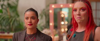 Movie still from “Making It Up” (2023), directed by Guillermo Calderón – A woman in a black jacket and a man in a black suit; Close Up shot, Over the shoulder angle