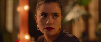 Movie still from “Making It Up” (2023), directed by Guillermo Calderón – A person wearing a red shirt; Close Up shot, Over the shoulder angle