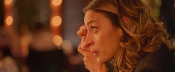 Movie still from “Making It Up” (2023), directed by Guillermo Calderón – A person holding their hand up to her face; Extreme Close Up shot, Over the shoulder angle