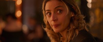 Movie still from “Making It Up” (2023), directed by Guillermo Calderón – A woman's face looking at the camera; Close Up shot, Over the shoulder angle