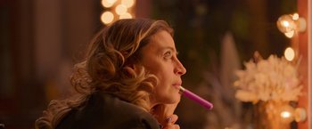 Movie still from “Making It Up” (2023), directed by Guillermo Calderón – A person holding a toothbrush in her mouth; Close Up shot, Over the shoulder angle