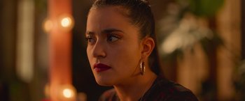 Movie still from “Making It Up” (2023), directed by Guillermo Calderón – A person wearing a red and black shirt; Close Up shot, Over the shoulder angle