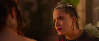 Movie still from “Making It Up” (2023), directed by Guillermo Calderón – A person looking at the camera; Close Up shot, Over the shoulder angle