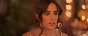 Movie still from “Making It Up” (2023), directed by Guillermo Calderón – A person wearing a dress; Close Up shot, Over the shoulder angle