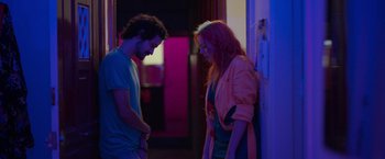 Movie still from “Making It Up” (2023), directed by Guillermo Calderón – A man and a woman standing next to each other; Medium shot, Over the shoulder angle