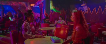 Movie still from “Making It Up” (2023), directed by Guillermo Calderón – A man and a woman sitting at a table in a restaurant; Medium shot, Over the shoulder angle