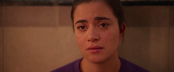 Movie still from “Making It Up” (2023), directed by Guillermo Calderón – A person with a purple shirt; Close Up shot, High angle