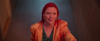 Movie still from “Making It Up” (2023), directed by Guillermo Calderón – A woman with red hair and a green shirt; Medium shot, High angle