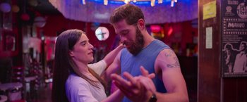 Movie still from “Making It Up” (2023), directed by Guillermo Calderón – A man and a woman are dancing together; Medium shot, Over the shoulder angle