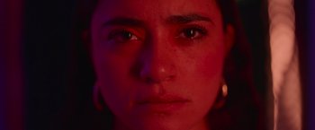 Movie still from “Making It Up” (2023), directed by Guillermo Calderón – A woman's face in red light; Extreme Close Up shot, Low angle