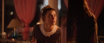 Movie still from “Making It Up” (2023), directed by Guillermo Calderón – A woman is looking at something in the distance; Close Up shot, Over the shoulder angle