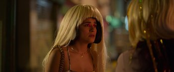 Movie still from “Making It Up” (2023), directed by Guillermo Calderón – A woman with a blonde wig and red eyes; Close Up shot, Over the shoulder angle