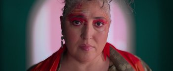 Movie still from “Making It Up” (2023), directed by Guillermo Calderón – A person wearing makeup on their face; Close Up shot, Low angle