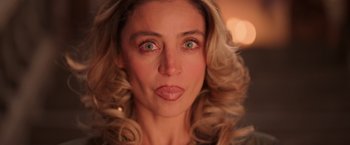 Movie still from “Making It Up” (2023), directed by Guillermo Calderón – A person with long blonde hair; Close Up shot, Over the shoulder angle