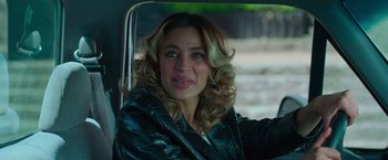 Movie still from “Making It Up” (2023), directed by Guillermo Calderón – A woman in a leather jacket sitting in a car; Close Up shot, Over the shoulder angle