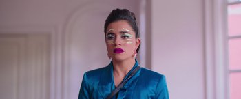 Movie still from “Making It Up” (2023), directed by Guillermo Calderón – A woman with green and yellow makeup on her face; Close Up shot, Low angle