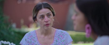 Movie still from “Making It Up” (2023), directed by Guillermo Calderón – A person wearing a blue and pink shirt; Close Up shot, Over the shoulder angle