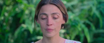 Movie still from “Making It Up” (2023), directed by Guillermo Calderón – A person's face with eyes closed; Close Up shot, High angle