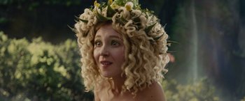 Movie still from “Maleficent” (2014), directed by Robert Stromberg – A woman wearing a wreath of flowers on top of her head; Close Up shot, Over the shoulder angle