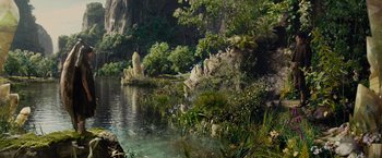 Movie still from “Maleficent” (2014), directed by Robert Stromberg – A lake surrounded by trees and bushes; Extreme Wide shot, High angle