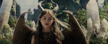 Movie still from “Maleficent” (2014), directed by Robert Stromberg – A young girl dressed up as maleficent for halloween; Medium shot, High angle