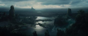 Movie still from “Maleficent” (2014), directed by Robert Stromberg – An aerial view of a lake with a castle in the background; Extreme Wide shot, High angle