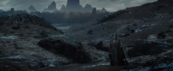Movie still from “Maleficent” (2014), directed by Robert Stromberg – A woman is standing in the middle of a field; Extreme Wide shot, High angle