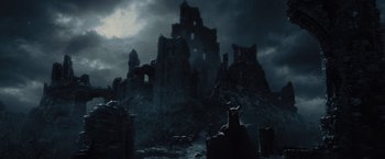 Movie still from “Maleficent” (2014), directed by Robert Stromberg – A dark picture of a castle in the middle of the night; Extreme Wide shot, High angle