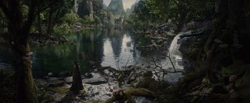 Movie still from “Maleficent” (2014), directed by Robert Stromberg – A man standing next to a body of water; Extreme Wide shot, High angle