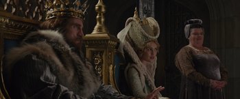 Movie still from “Maleficent” (2014), directed by Robert Stromberg – A man and a woman sitting on a throne; Medium shot, Over the shoulder angle