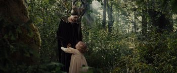 Movie still from “Maleficent” (2014), directed by Robert Stromberg – A woman in a black dress and a little girl in a pink dress; Medium shot, Over the shoulder angle