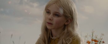Movie still from “Maleficent” (2014), directed by Robert Stromberg – A young girl with blonde hair and blue eyes; Close Up shot, Low angle