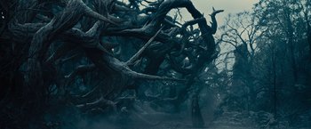 Movie still from “Maleficent” (2014), directed by Robert Stromberg – A man standing in the middle of a forest; Extreme Wide shot, Low angle