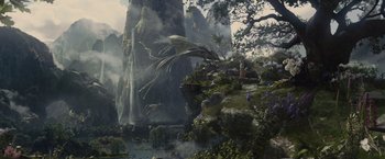 Movie still from “Maleficent” (2014), directed by Robert Stromberg – An image of a dragon flying over a mountain; Extreme Wide shot, High angle