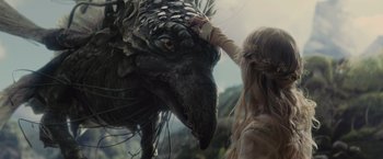 Movie still from “Maleficent” (2014), directed by Robert Stromberg – A woman touching the head of a dragon; Close Up shot, Low angle
