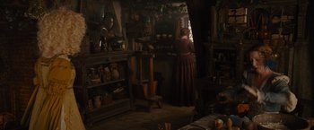 Movie still from “Maleficent” (2014), directed by Robert Stromberg – A woman standing in a room filled with pots and pans; Wide shot, Low angle