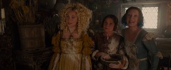 Movie still from “Maleficent” (2014), directed by Robert Stromberg – Two women dressed in medieval costumes and one is holding a bowl; Medium shot, Low angle