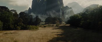 Movie still from “Maleficent” (2014), directed by Robert Stromberg – A field that has some trees in the grass; Extreme Wide shot, High angle