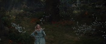 Movie still from “Maleficent” (2014), directed by Robert Stromberg – A woman in a blue dress running in the woods; Wide shot, High angle