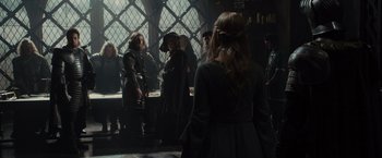 Movie still from “Maleficent” (2014), directed by Robert Stromberg – A group of people standing in a room; Medium shot, Over the shoulder angle