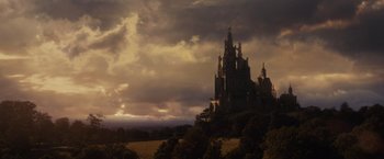 Movie still from “Maleficent” (2014), directed by Robert Stromberg – A castle like building in the middle of a field; Extreme Wide shot, Low angle