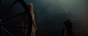 Movie still from “Maleficent” (2014), directed by Robert Stromberg – A woman standing in the middle of a dark forest; Medium shot, Low angle