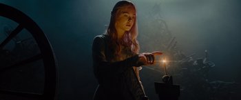 Movie still from “Maleficent” (2014), directed by Robert Stromberg – A woman is holding a light in her hand; Medium shot, Low angle