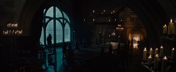 Movie still from “Maleficent” (2014), directed by Robert Stromberg – A dark room with a table and chairs in it; Extreme Wide shot, High angle