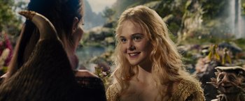 Movie still from “Maleficent” (2014), directed by Robert Stromberg – A young woman with long blonde curly hair; Close Up shot, Over the shoulder angle